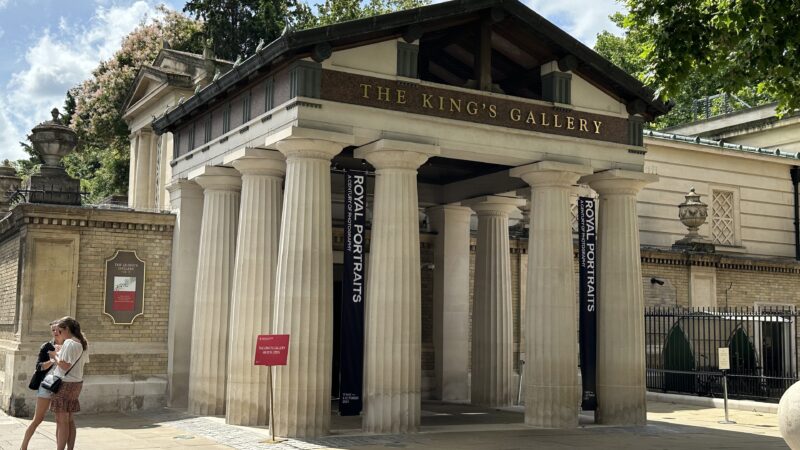 Exterior entrance of The King's Gallery with columns and banners reading Royal Portraits, with visitors walking past.