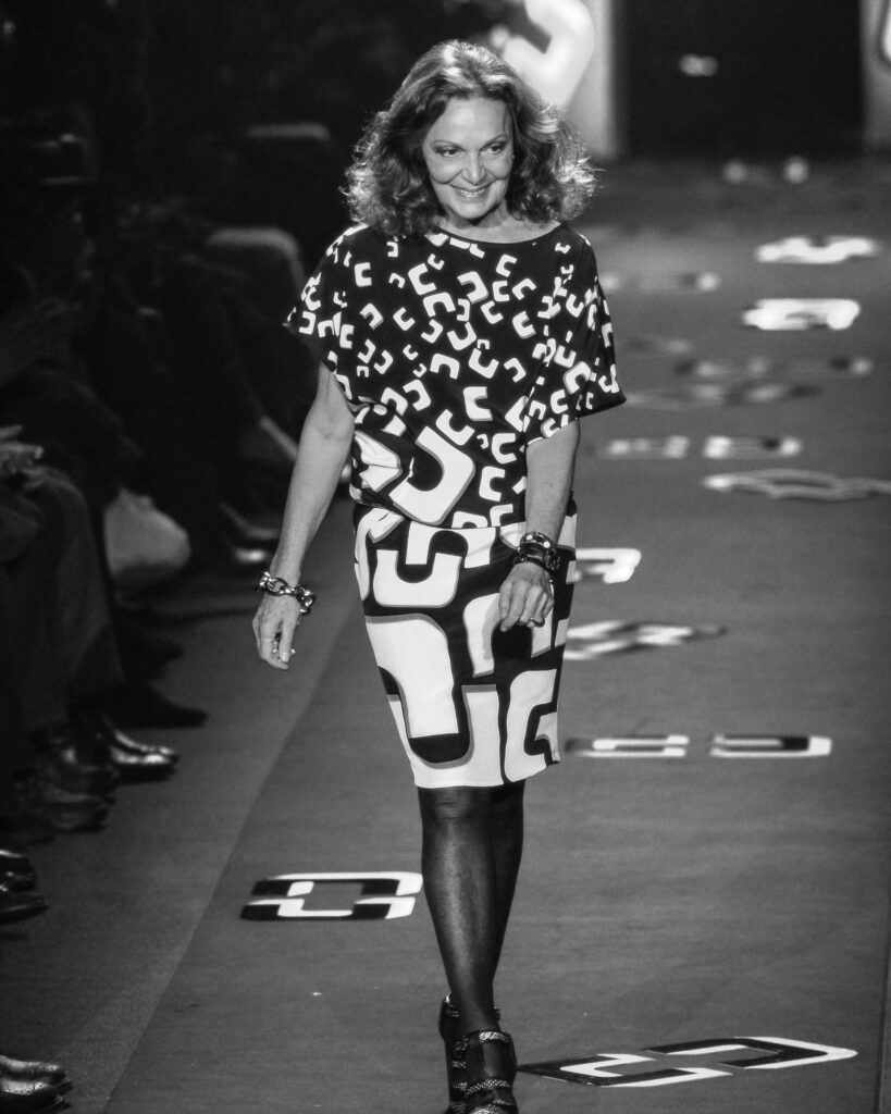 Diane von Furstenberg walks the runway in a patterned dress at the end of her fashion show.
