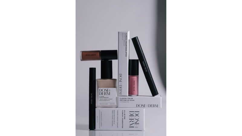 Product lineup of DOSE (OF) DERM makeup including foundation, lip stain, mascara, and packaging boxes.