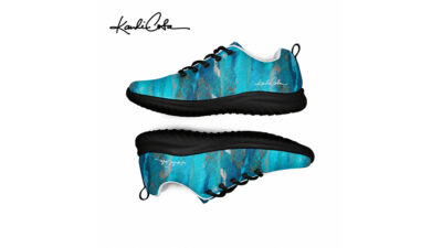 A pair of blue-and-black painted sneakers shown from side and sole views with a signature logo.
