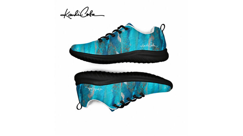 A pair of blue-and-black painted sneakers shown from side and sole views with a signature logo.