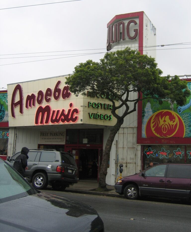 Exterior facade of the Amoeba Music record store on Haight Street in San Francisco with cars parked outside.