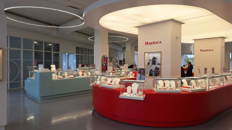 Interior of the Majorica pearl showroom in Manacor with red and teal display cases of jewelry.