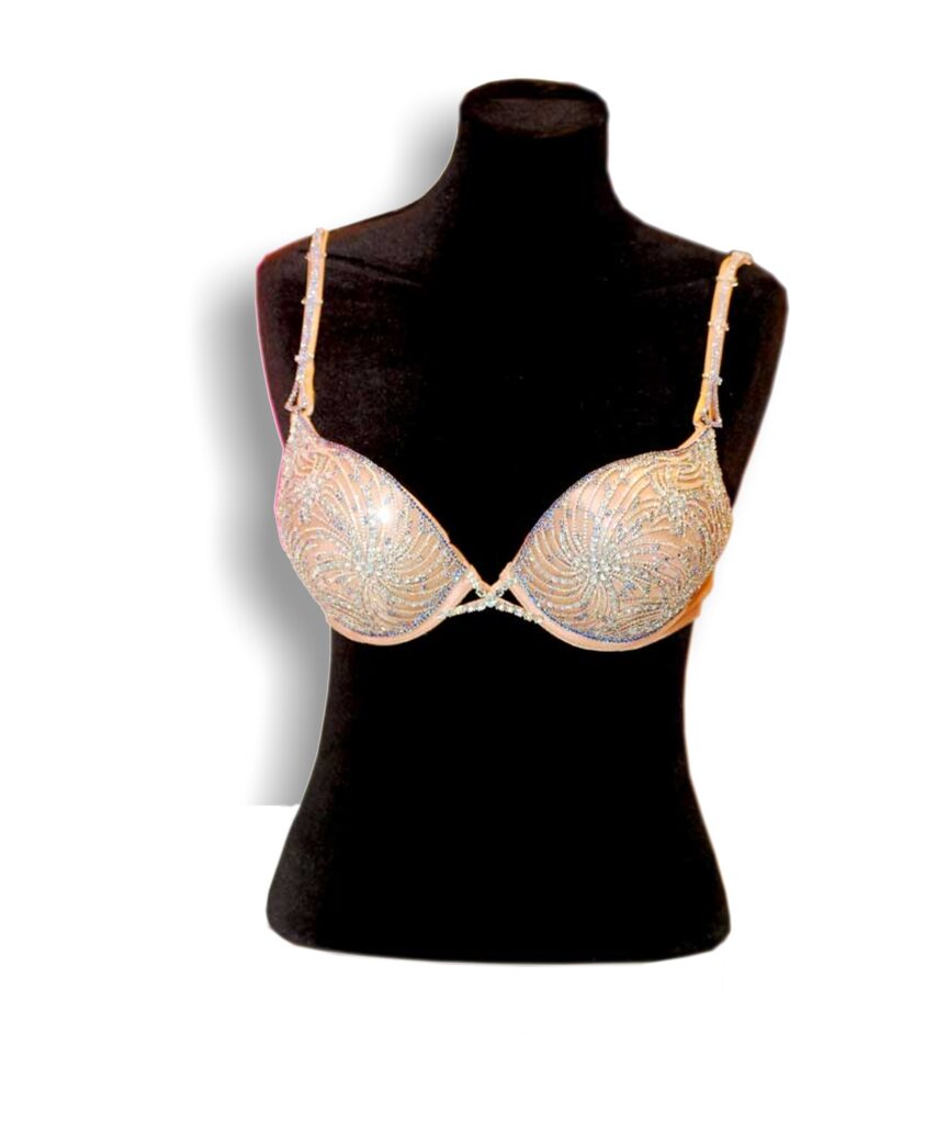 A rhinestone-embellished bra displayed on a black mannequin torso.